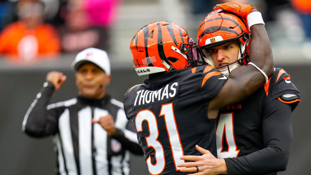 Cincinnati Bengals safety Michael Thomas (31) hugs punter Drue Chrisman (4) after he draws a foul being hit on a punt in the second quarter of the NFL Week 14 game between the Cincinnati Bengals and the Cleveland Browns at Paycor Stadium in Cincinnati on Sunday, Dec. 11, 2022. The Bengals led 13-3 at halftime. Cleveland Browns At Cincinnati Bengals Week 14